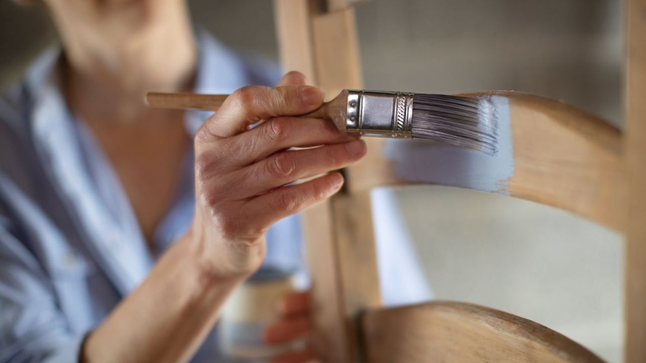 Someone painting a chair