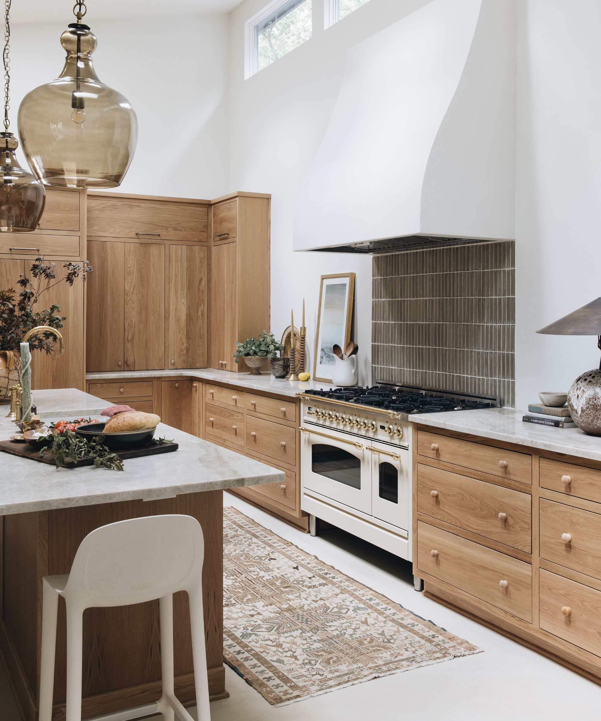 A wood kitchen with a white range cooker and tiled backsplash