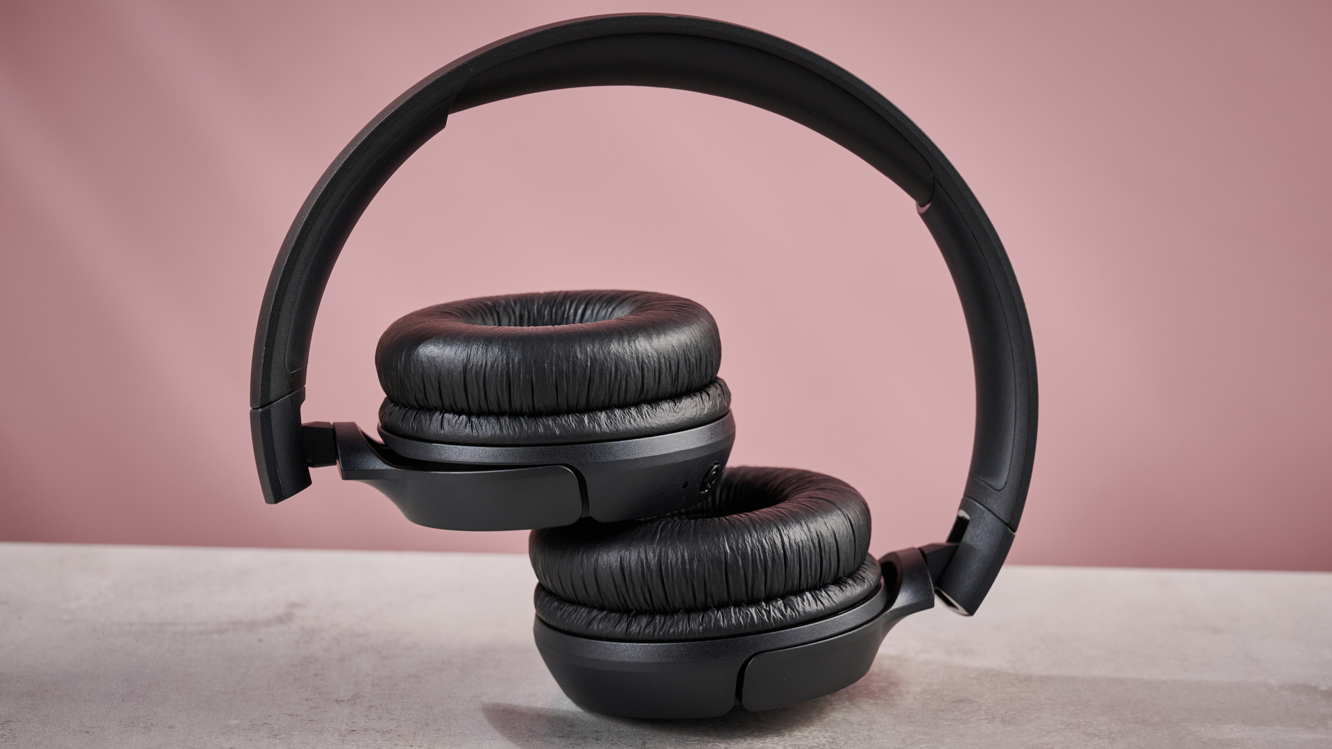JBL Tune 510BT folded against pink background
