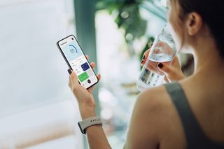 Woman using fitness app on smartphone