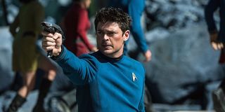 Doctor McCoy aiming a phaser in Star Trek: Beyond