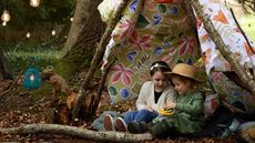 Kids in a woodland teepee den