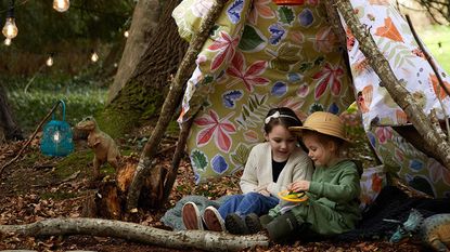 Kids in a woodland teepee den