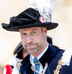 Prince William wearing a plumed hat and a cape