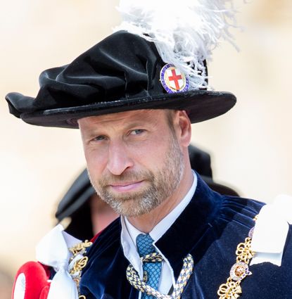 Prince William wearing a plumed hat and a cape 