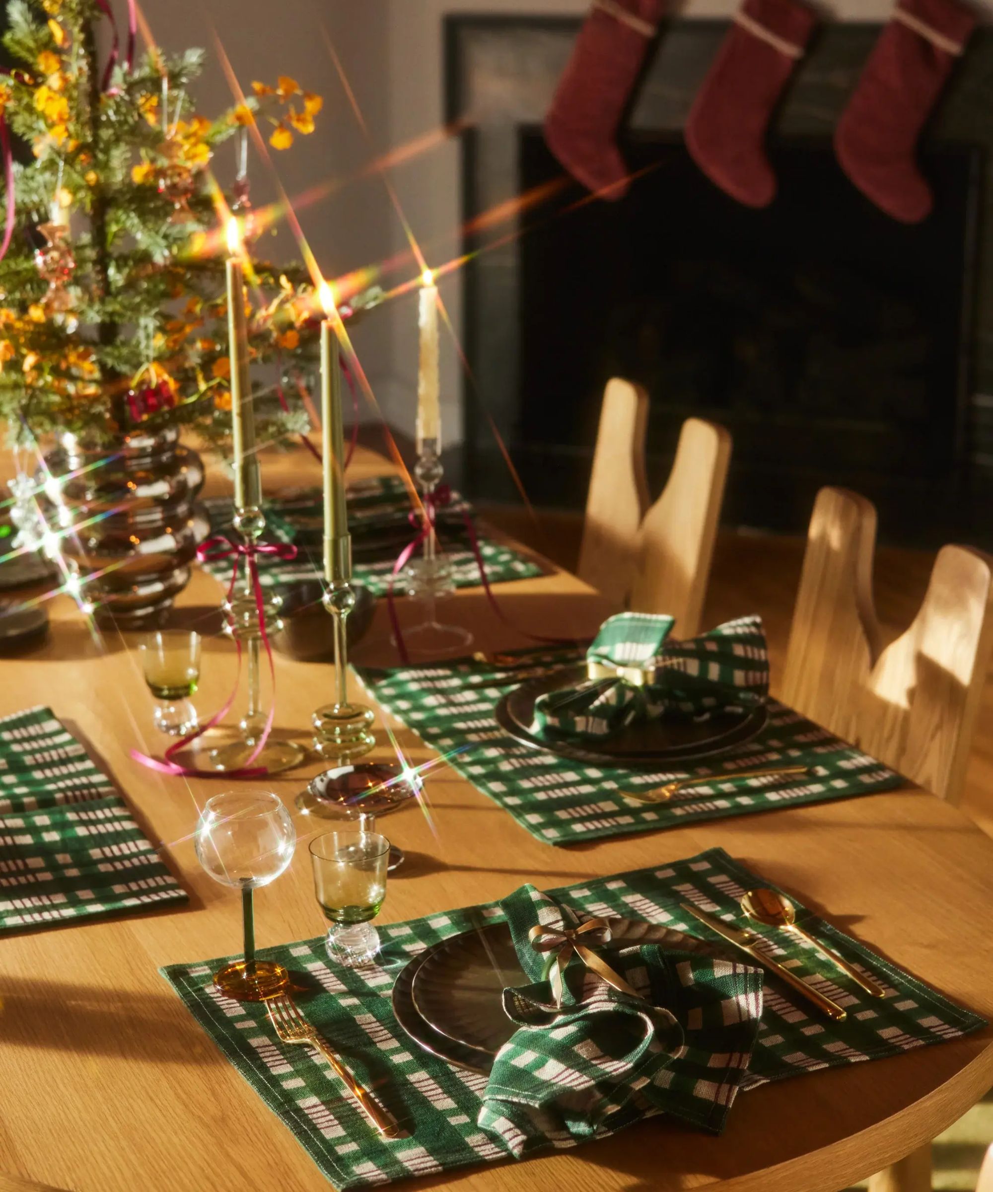 Christmas table decorated with gingham green mats and a mini tree