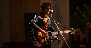 Timothée Chalamet as Bob Dylan plays a Gibson SJ-200 in a still from A Complete Unknown