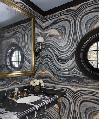 A bathroom backsplash idea with a full wall of grey striated marble