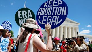 Abortion rights advocates with placards shown participating in a protest outside the US Supreme Court Building