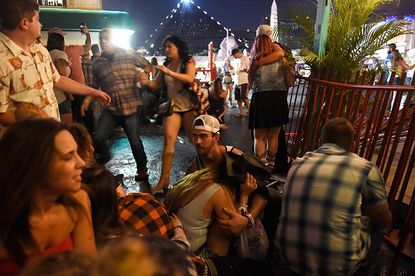Concertgoers shelter after shooting at the Route 91 Harvest Festival.