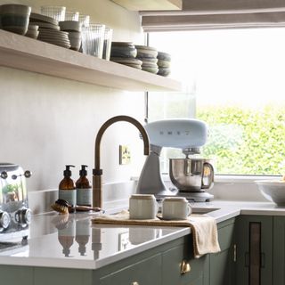 green kitchen worktop with sink and tap and food mixer