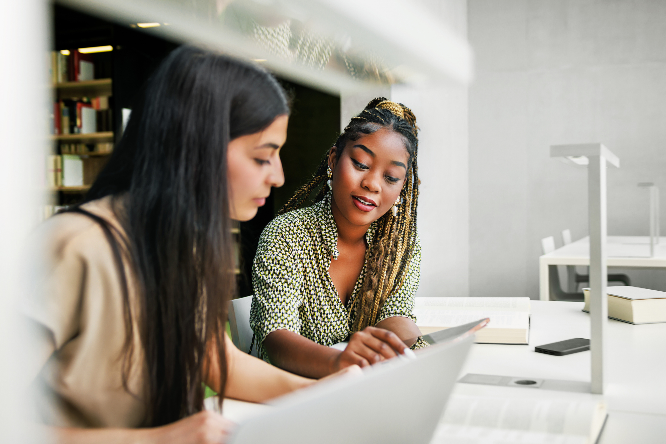 two women looking at a book