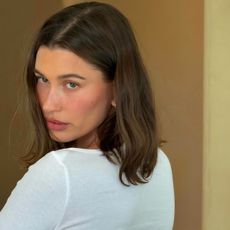 Hailey Bieber wearing a white Cou Cou Intimates bracelet-sleeve tee on Instagram