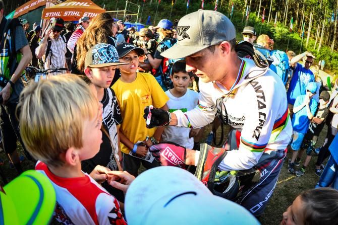 Hometown hero Greg Minnaar spends some time with tomorrow's stars after he finished third in the elite men's downhill