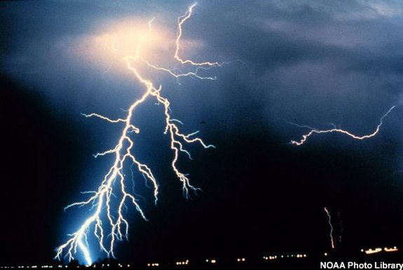 Multiple cloud-to-cloud and cloud-to-ground lightning strokes during a night-time thunderstorm.