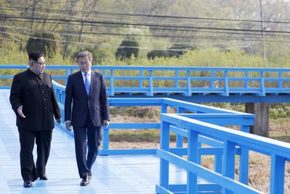 North Korean leader Kim Jong Un and South Korean President Moon Jae-in discuss