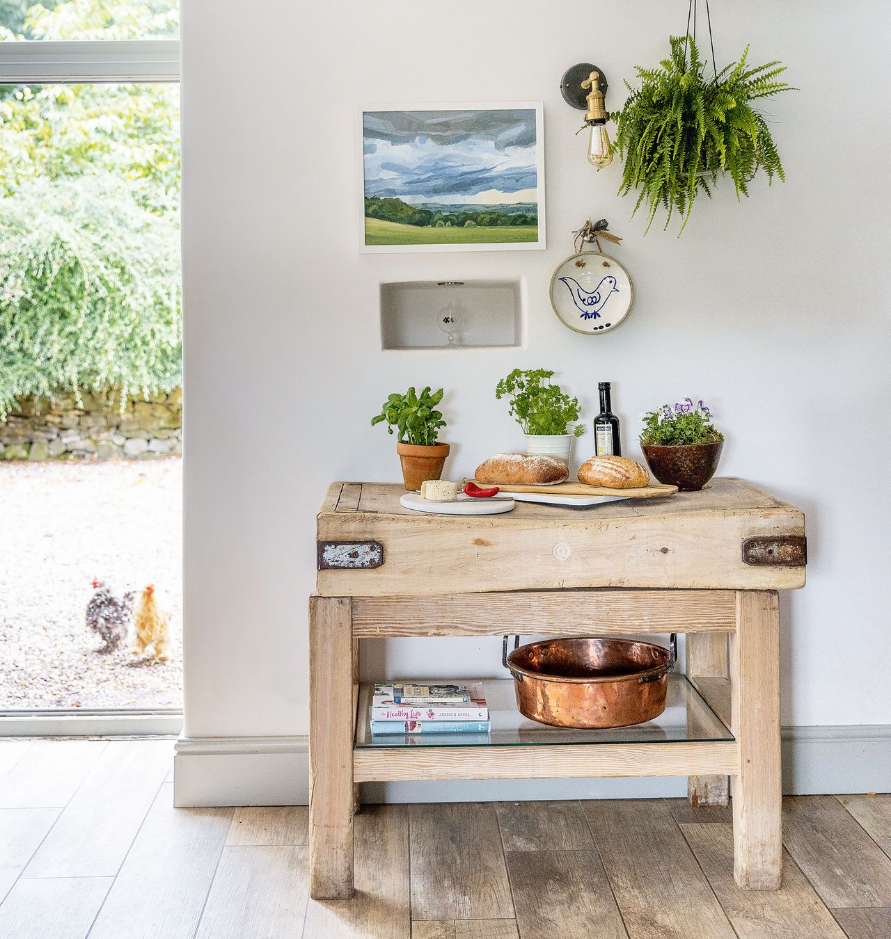 butchers block in kitchen with door open and hens outside