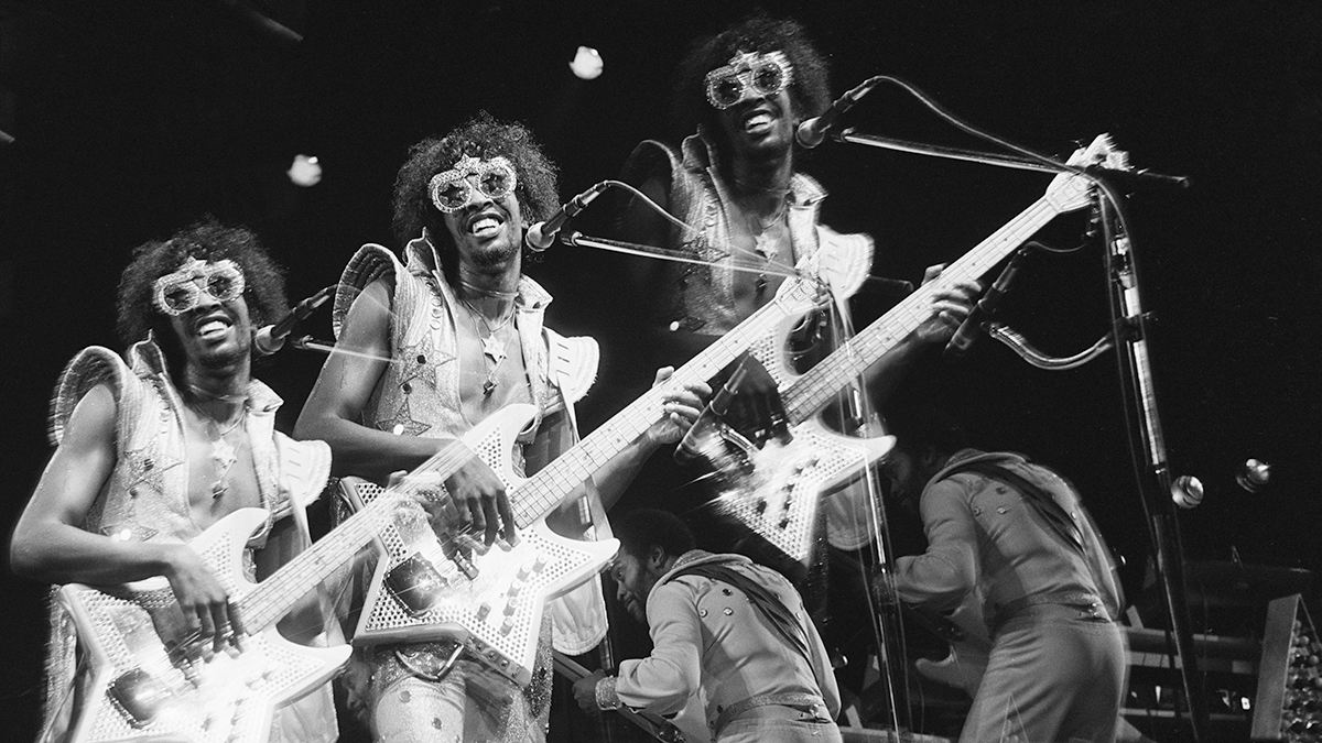 Triple exposure of Bootsy Collins, US funk bassist, playing a star-shaped bass guitar on stage during a live concert performance at the Hammersmith Odeon, in Hammersmith, London, England, Great Britain, in June 1978