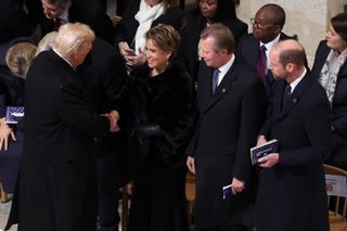 Prince William, Grand Duchess Maria Teresa, Grand Duke Henri of Luxembourg standing in a row and greeting Donald Trump, with everyone wearing black coats