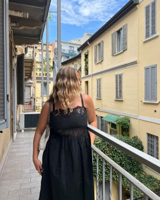 What to pack for Italy: @oliviamarcus wears a black midi dress