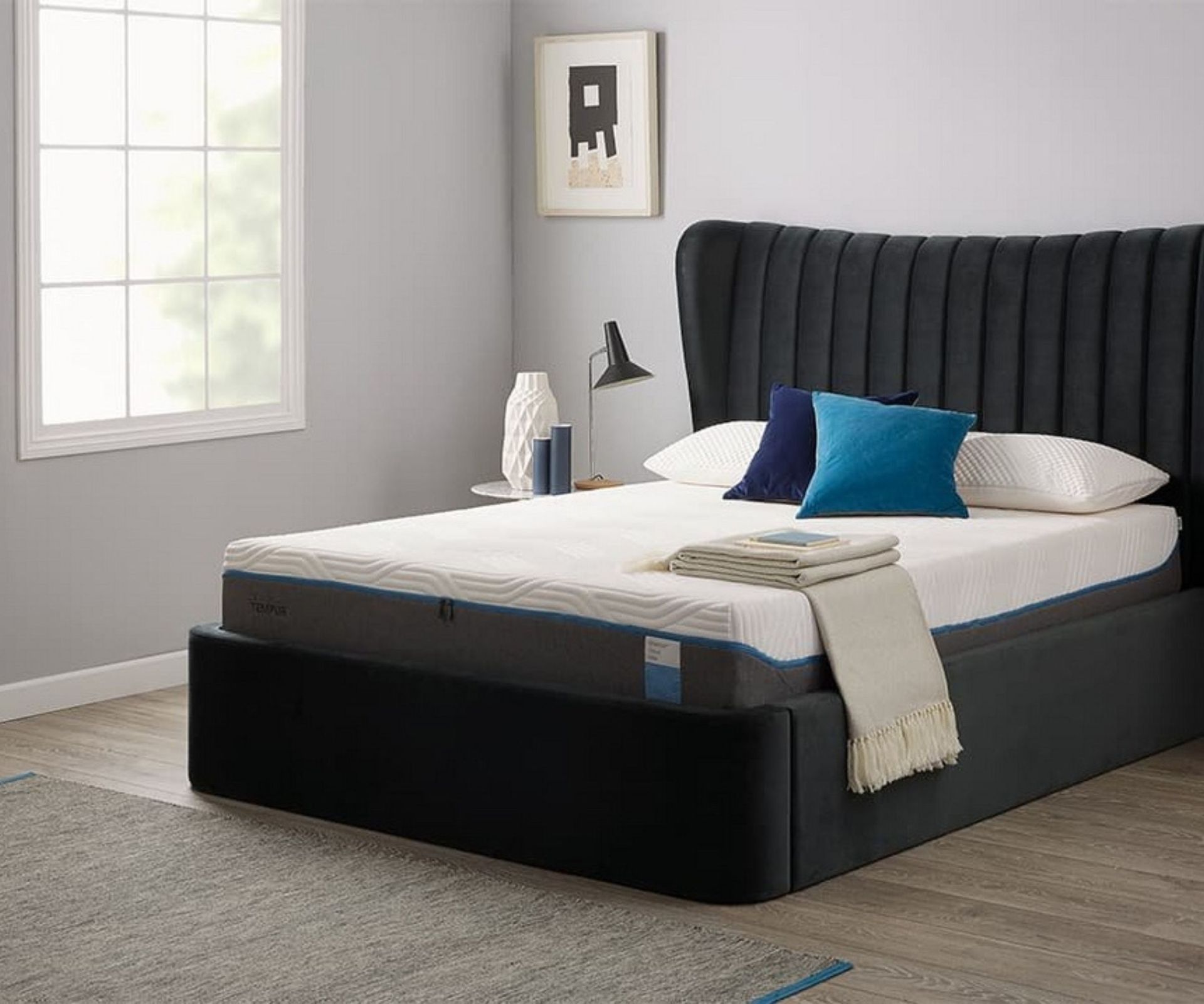 TEMPUR-Cloud Mattress on a bed against gray walls.