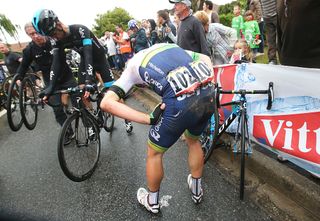 Michael Albasini of Switzerland and Orica Greenedge picks himself up following a crash 25km from the finish during stage 5