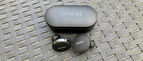 Denon PerL Pro and case, on a black table outside