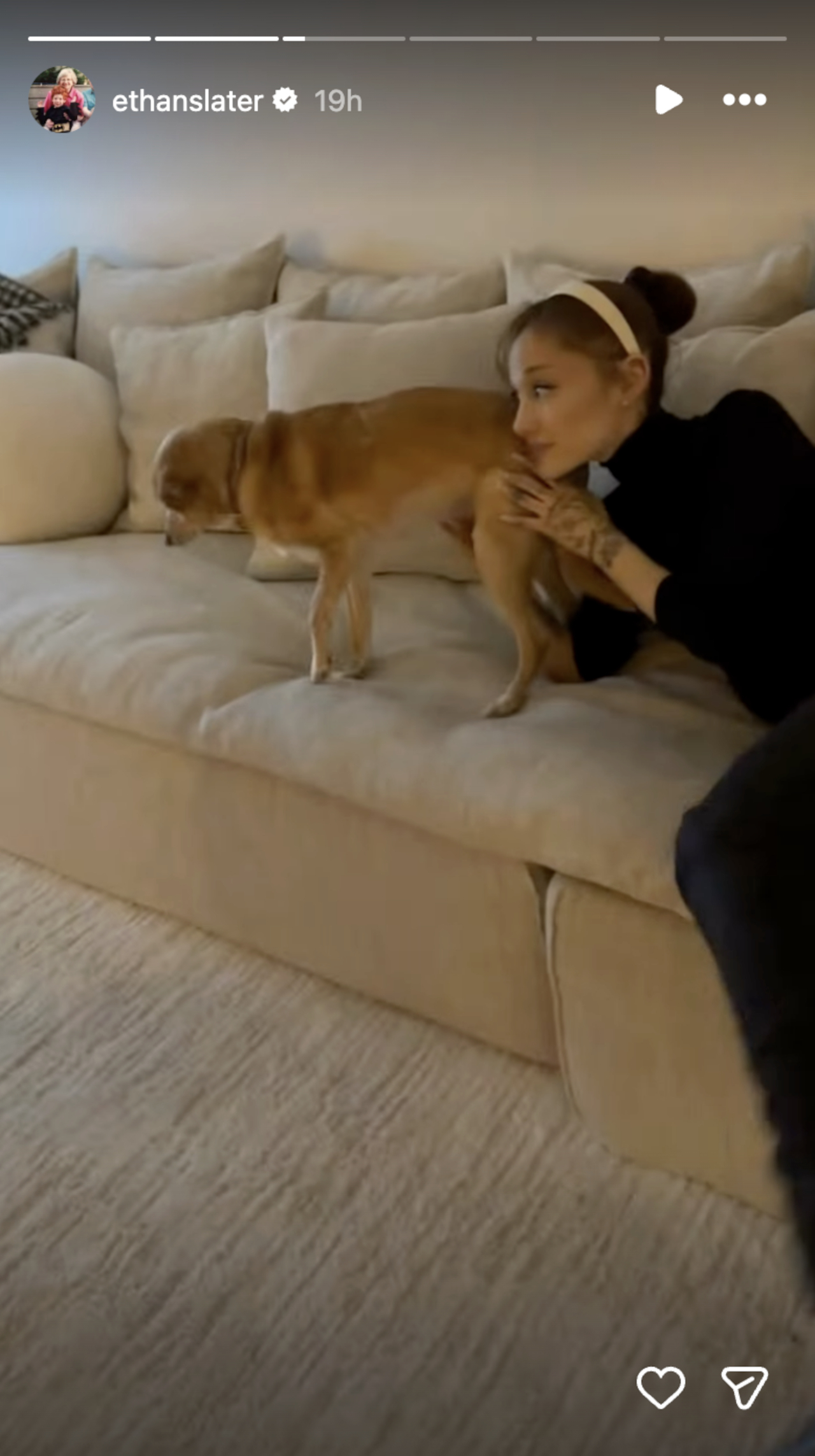 Ethan Slater shares a photo of Ariana Grande relaxing on a couch with a dog over the holidays.