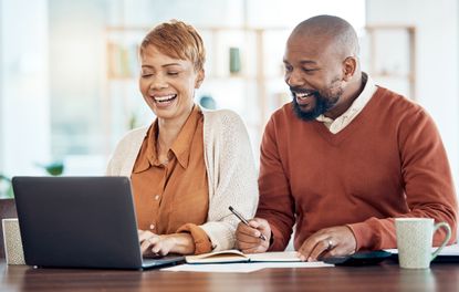 Older couple happily looking at finances