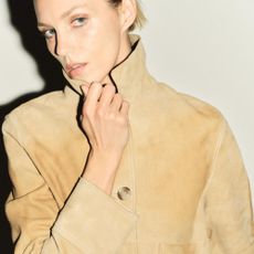 Woman wears yellow suede jacket