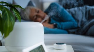 woman sleeping next to her humidifier