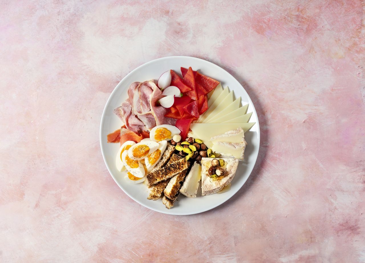 Cheese plate on pink background 