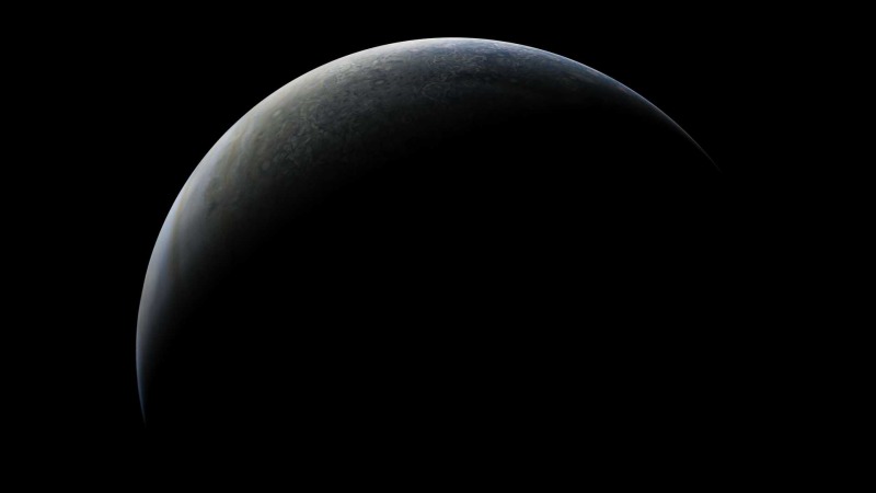 A backlit image of Jupiter captured by Juno.