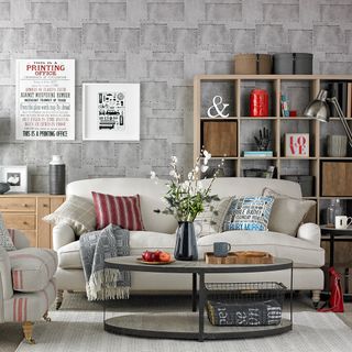 living room with white sofaset with cushions and wooden shelves