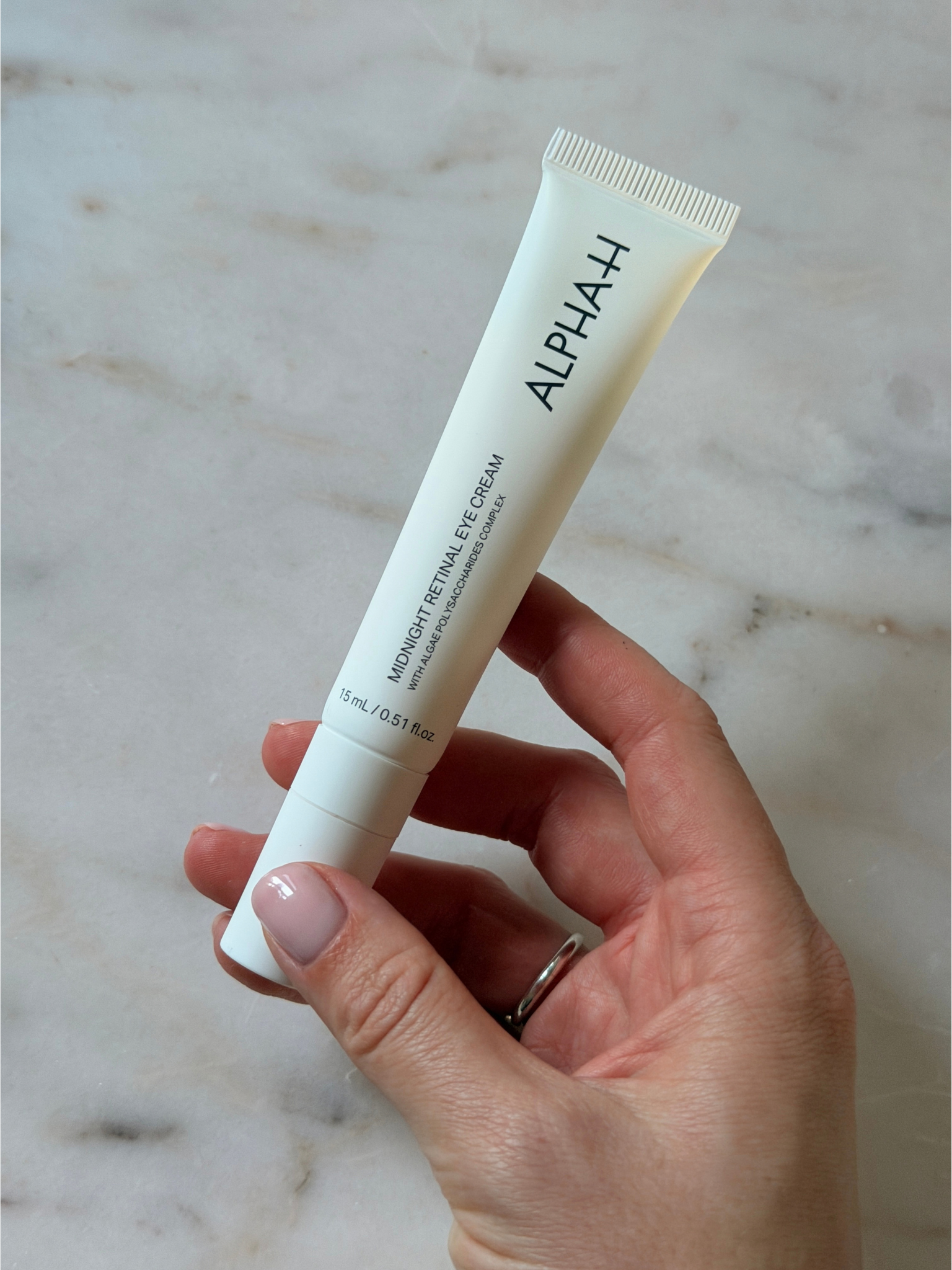 Freelance beauty editor Grace Day holding the Alpha-H eye cream