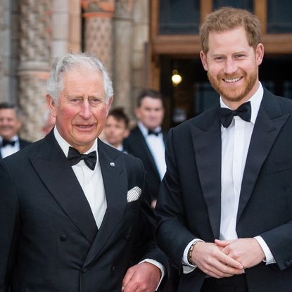 King Charles and Prince Harry wearing tuxedos and smiling