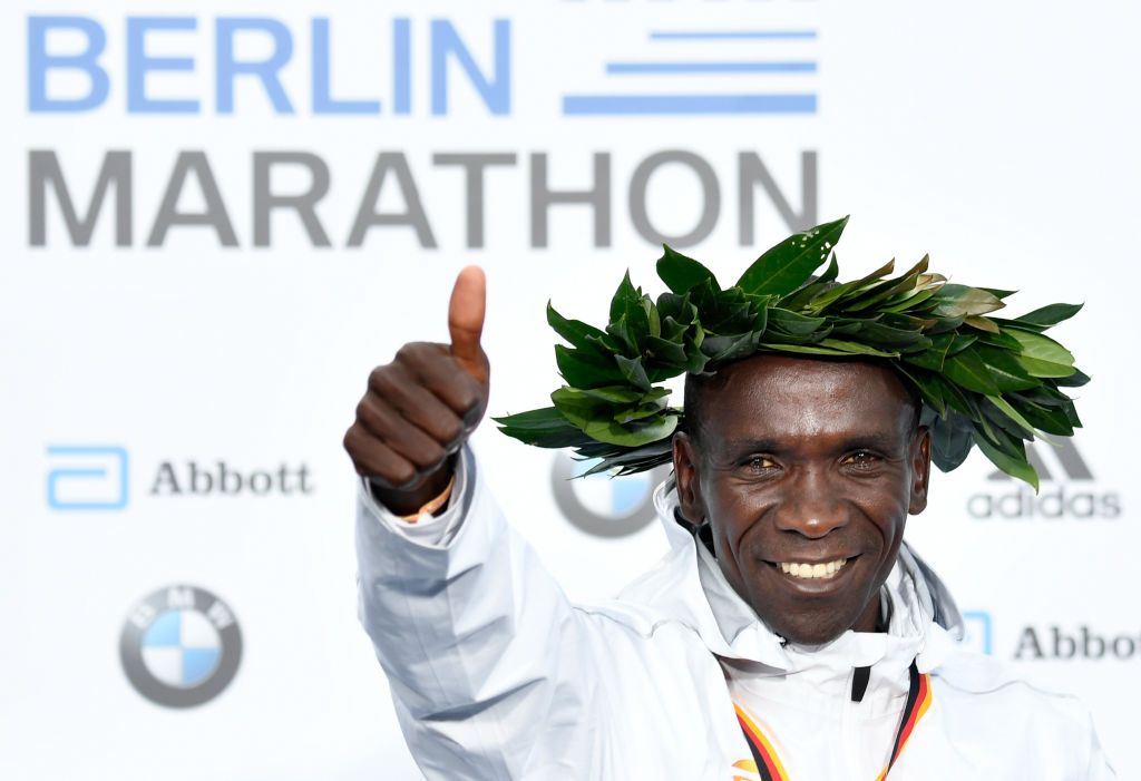 Kenya&amp;#039;s Eliud Kipchoge celebrates on the podium during the winner&amp;#039;s ceremony after winning the Berlin Marathon setting a new world record on September 16, 2018 in Berlin.