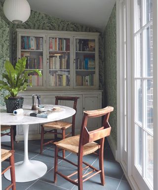 Dining nook with round white table and book shelves