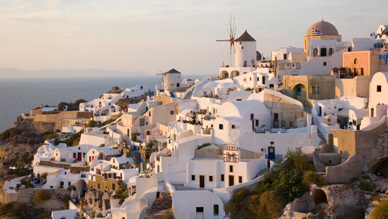 Whitewashed houses on Santorini, Greece, against ocean backdrop