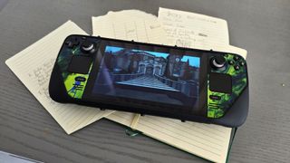 A Steam Deck lying on a notebook