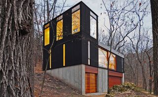 stacked black cabin by Johnsen Schmaling Architects in muscoda, usa