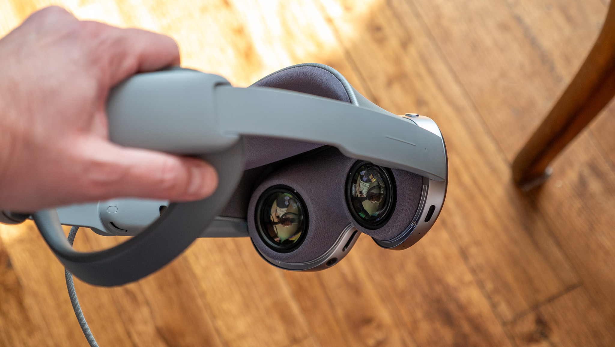 Holding a Samsung Galaxy XR and looking at the lenses and head strap