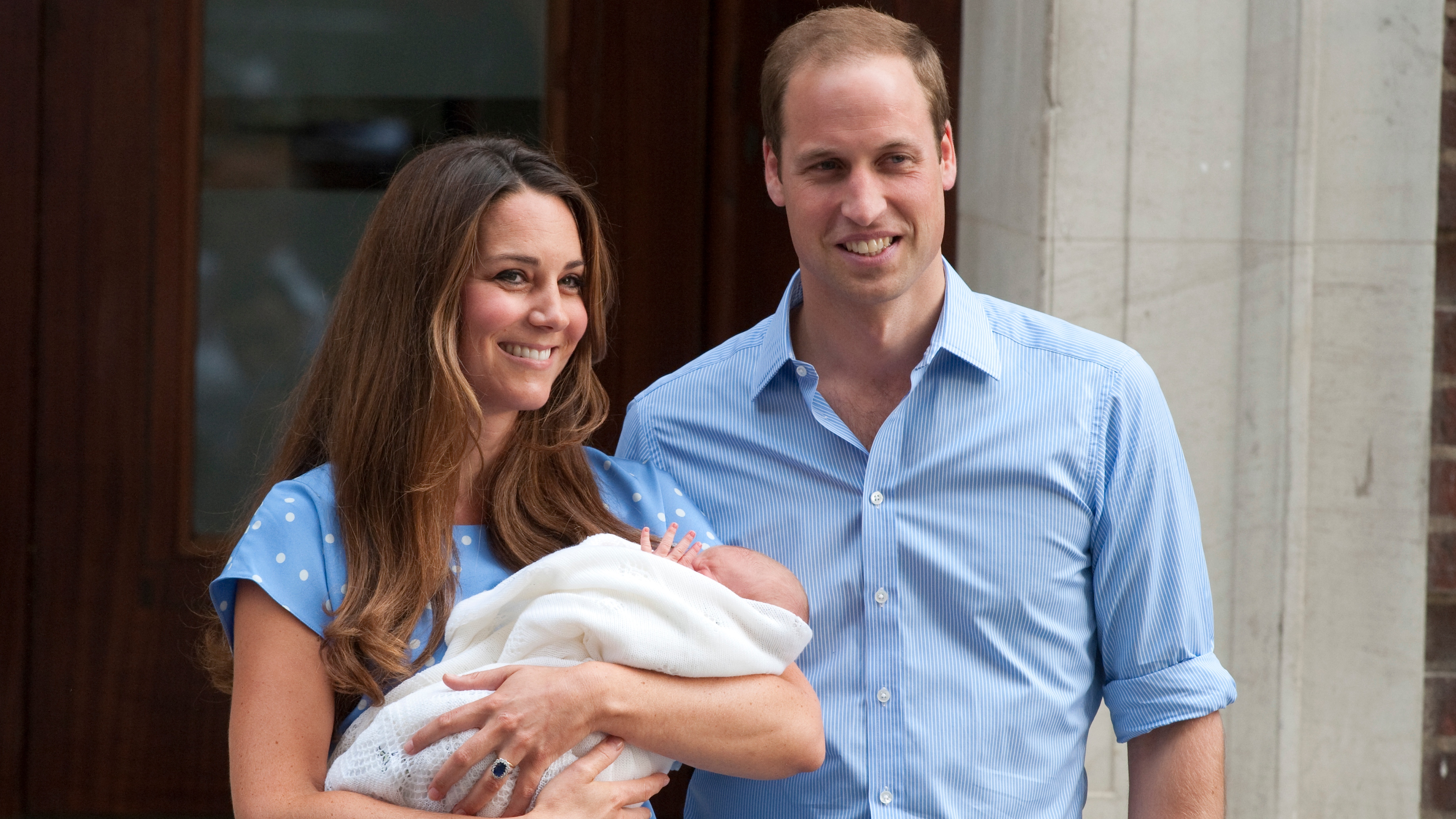 Catherine, Princess of Wales holds Prince George and stands next to Prince William outside St Mary&#039;s Hospital