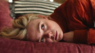 Margo (Elle Fanning) lying on her side in a scene from Apple TV's "Margo's Got Money Troubles"