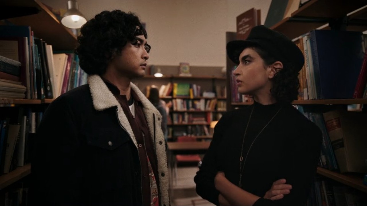 Sarah Yarkin and Kristian Ventura looking at each other in School Spirits Season 3.