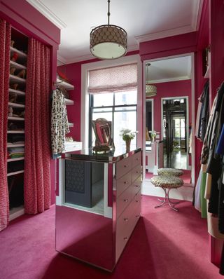 Pink dressing room with mirrored island