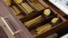 a drawer fillwed with gold cutlery