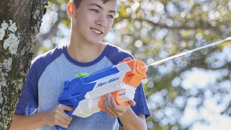 The best water gun 2022, image shows boy playing with a Super Soaker