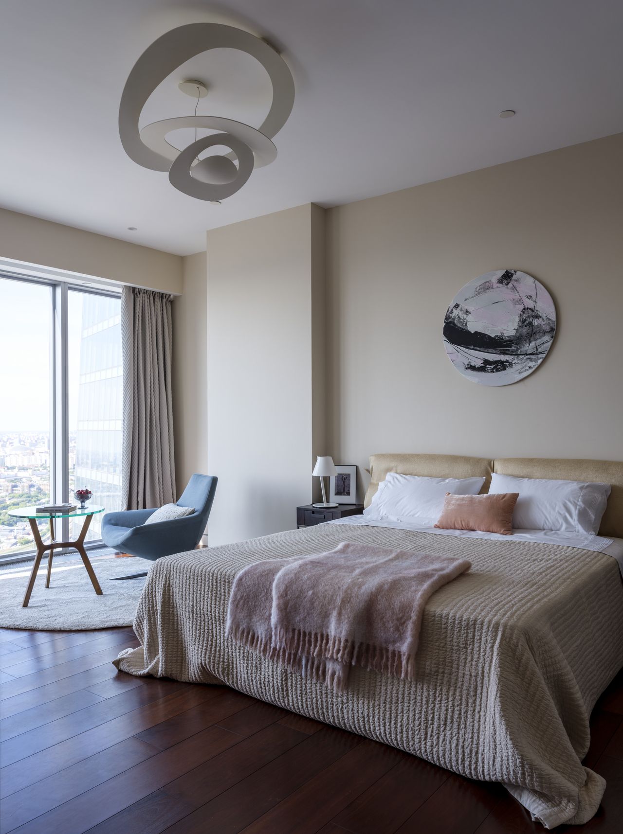 A bedroom with a sculptural lighting piece