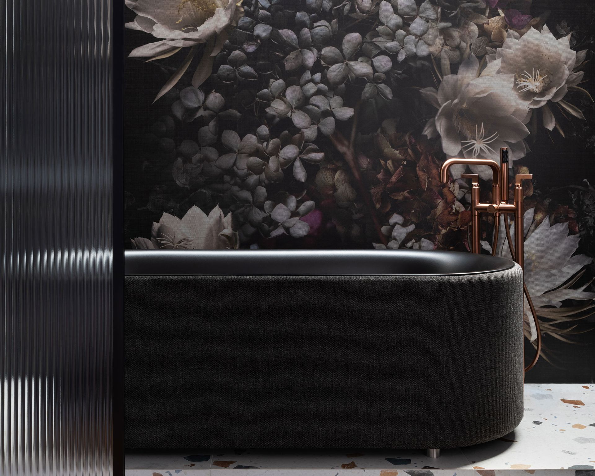 Bathroom trend with black tub and dark floral wallpaper
